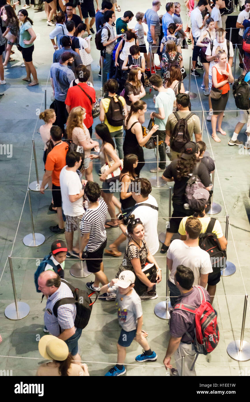 New York City,NY NYC Manhattan,Midtown,Museum of Modern Art,MoMA,art museum,lobby,overhead view,ticket desk,roped line,busy,crowded,adult,adults,man m Stock Photo