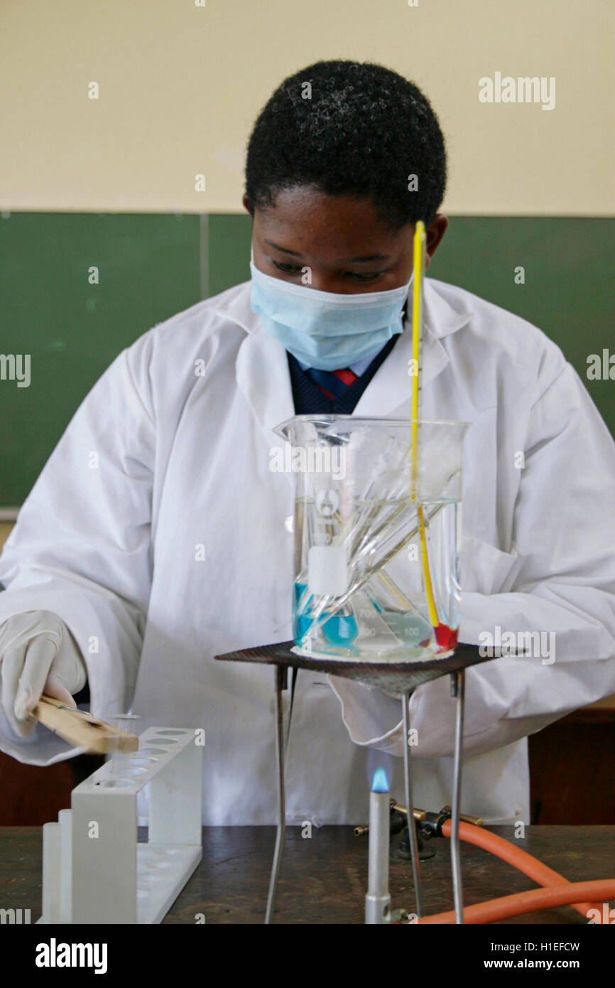 School girl doing experiment in school lab,  St Mark's School, Mbabane, Hhohho, Kingdom of Swaziland Stock Photo