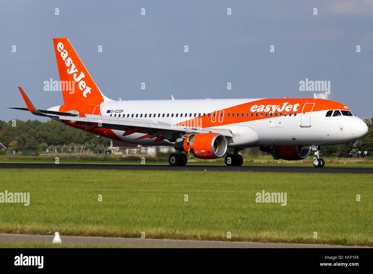 EasyJet Airbus A320 touches down on runway 18R at Amsterdam Schipol airport. Stock Photo