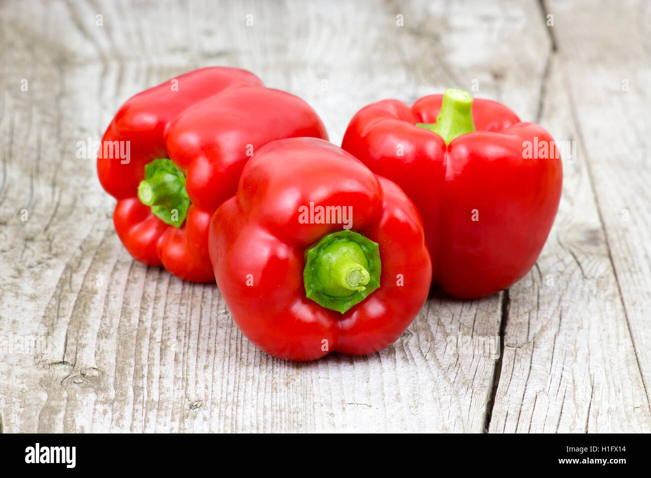 red peppers on wooden background Stock Photo - Alamy