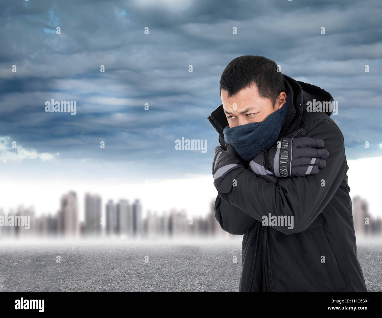 Young man tightening body in outdoors cold weather Stock Photo - Alamy