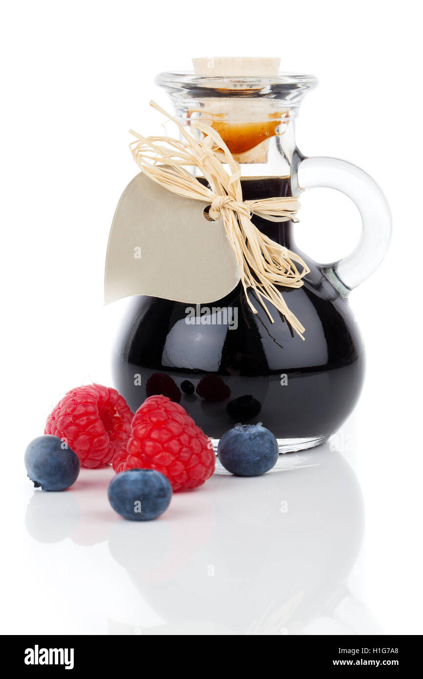 blueberry raspberry syrup in glass bottle or mixture, with hea Stock