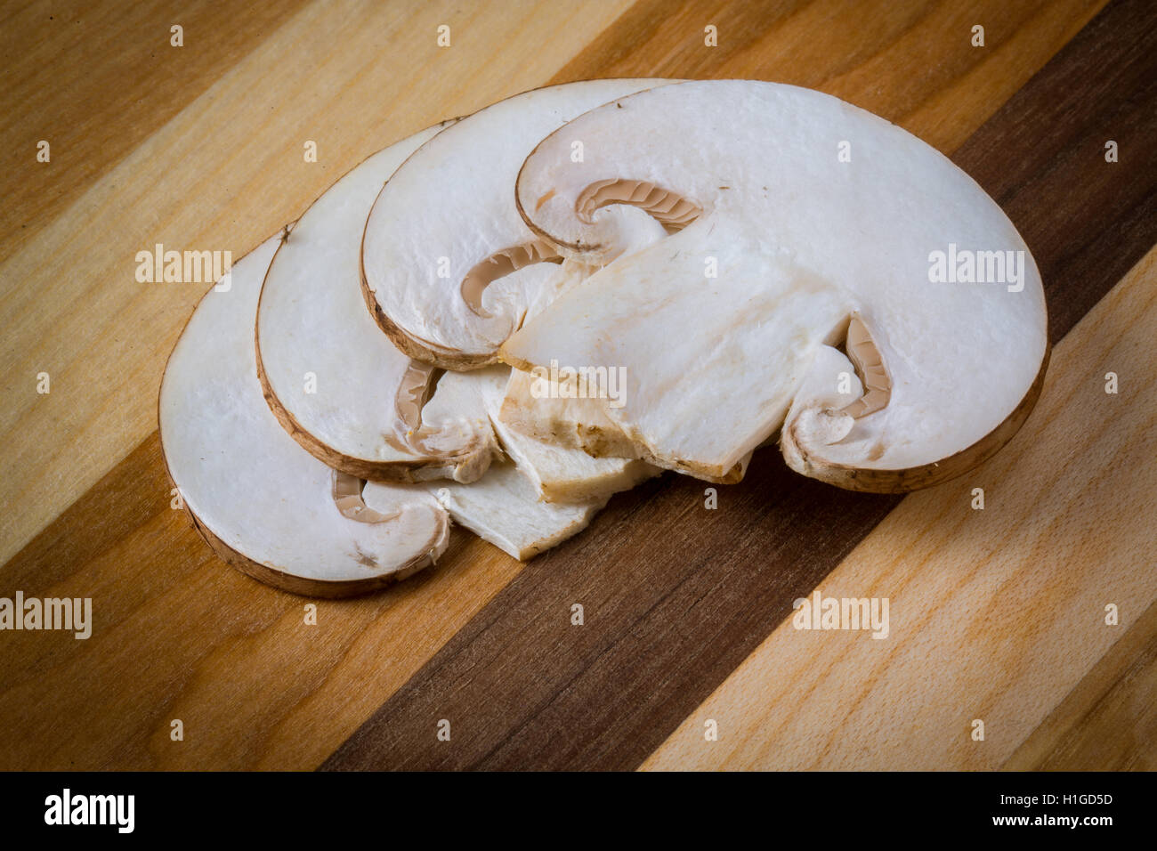 Crimini (Baby Bella) mushroom, sliced and placed in layers on striped