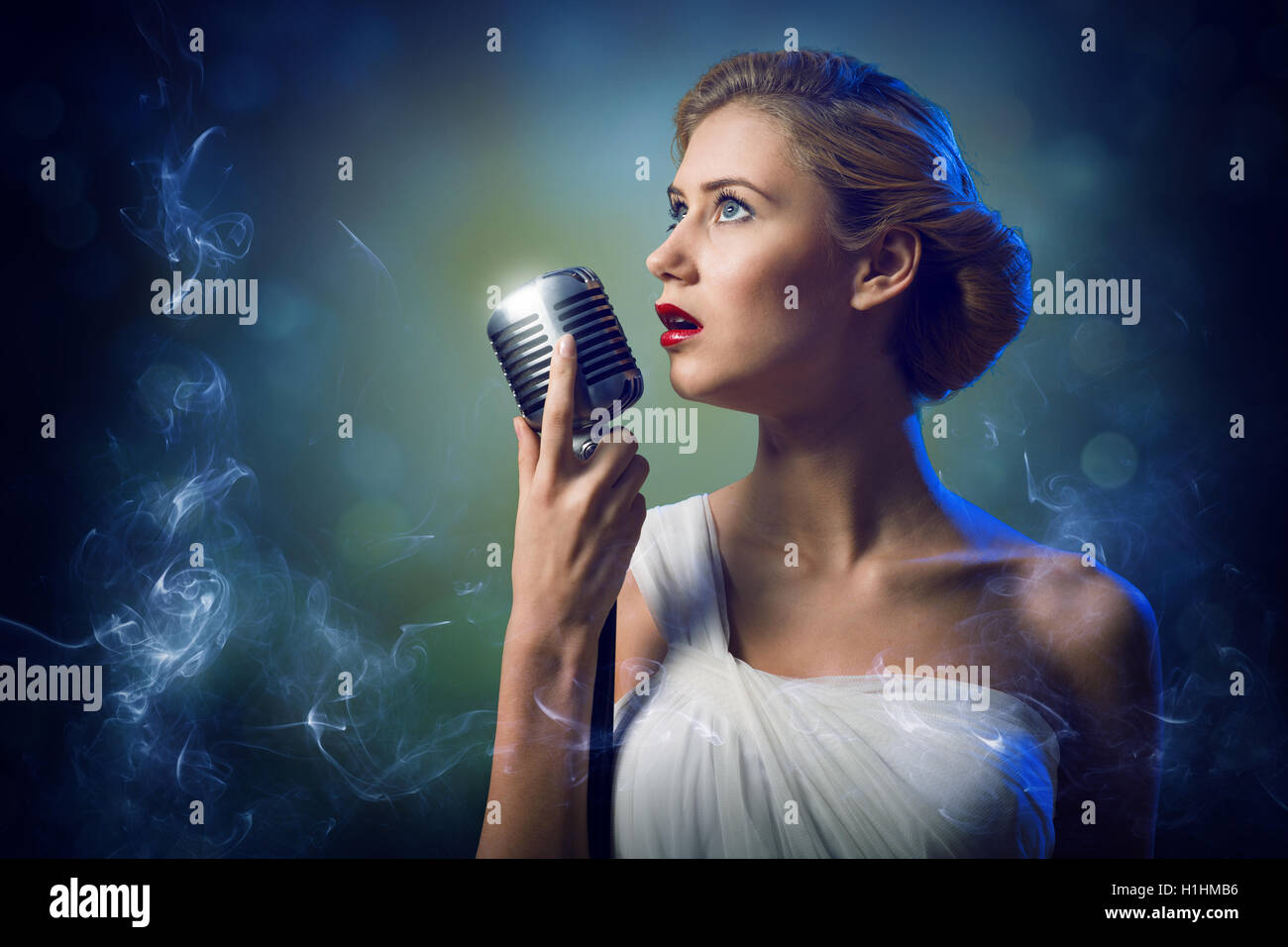 attractive female singer with microphone Stock Photo - Alamy