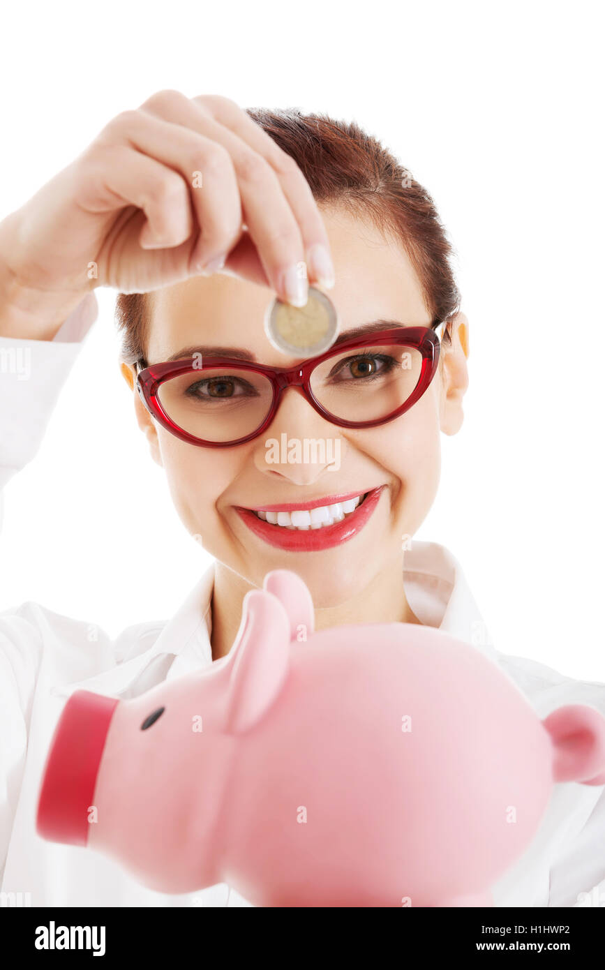 Beautiful business woman with coin and piggy- bank Stock Photo - Alamy