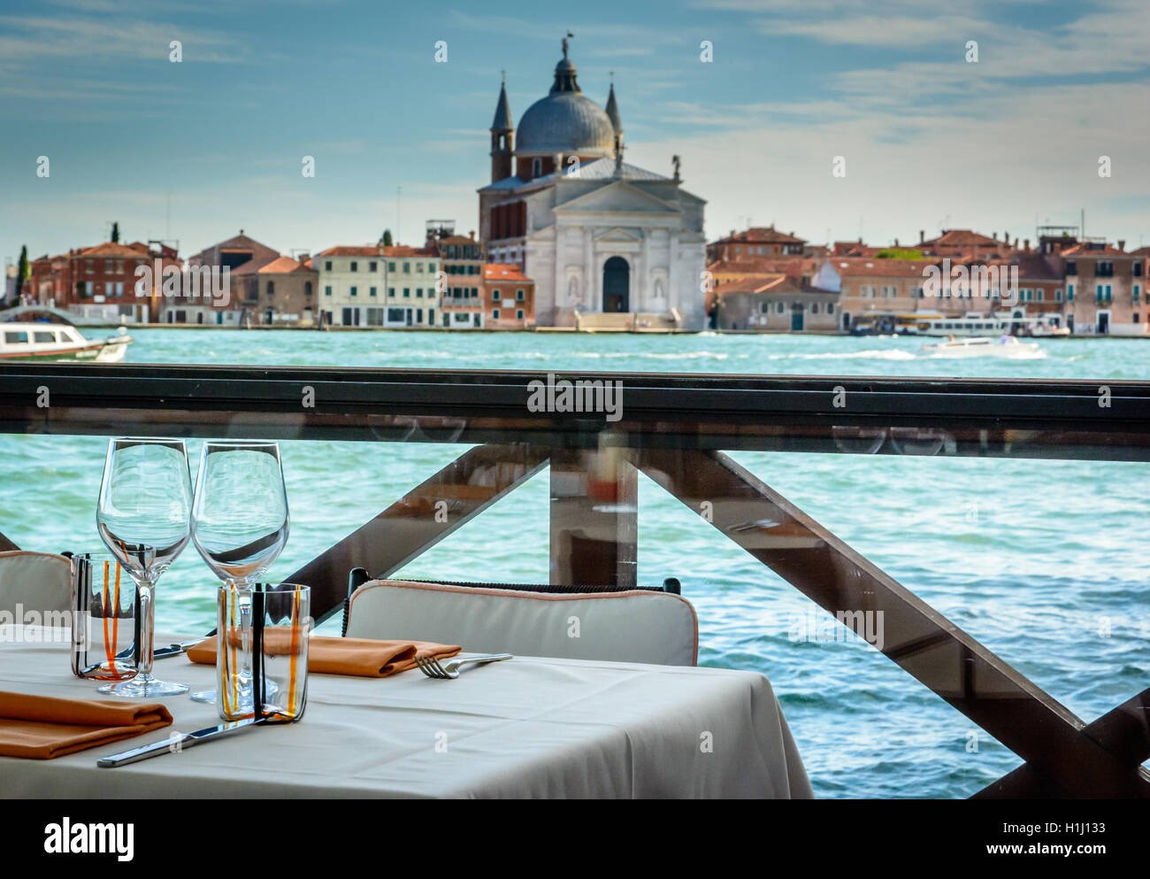 Dining tables in outdoor restaurant and Church of the Santissimo
