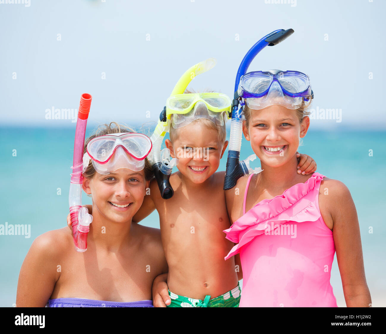 three happy children on beach Stock Photo Alamy
