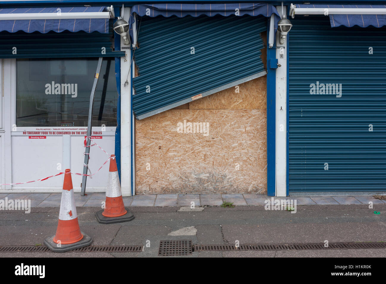 A boarded-up cafe with wonky shutters on the Western Esplanade at Southend. Stock Photo