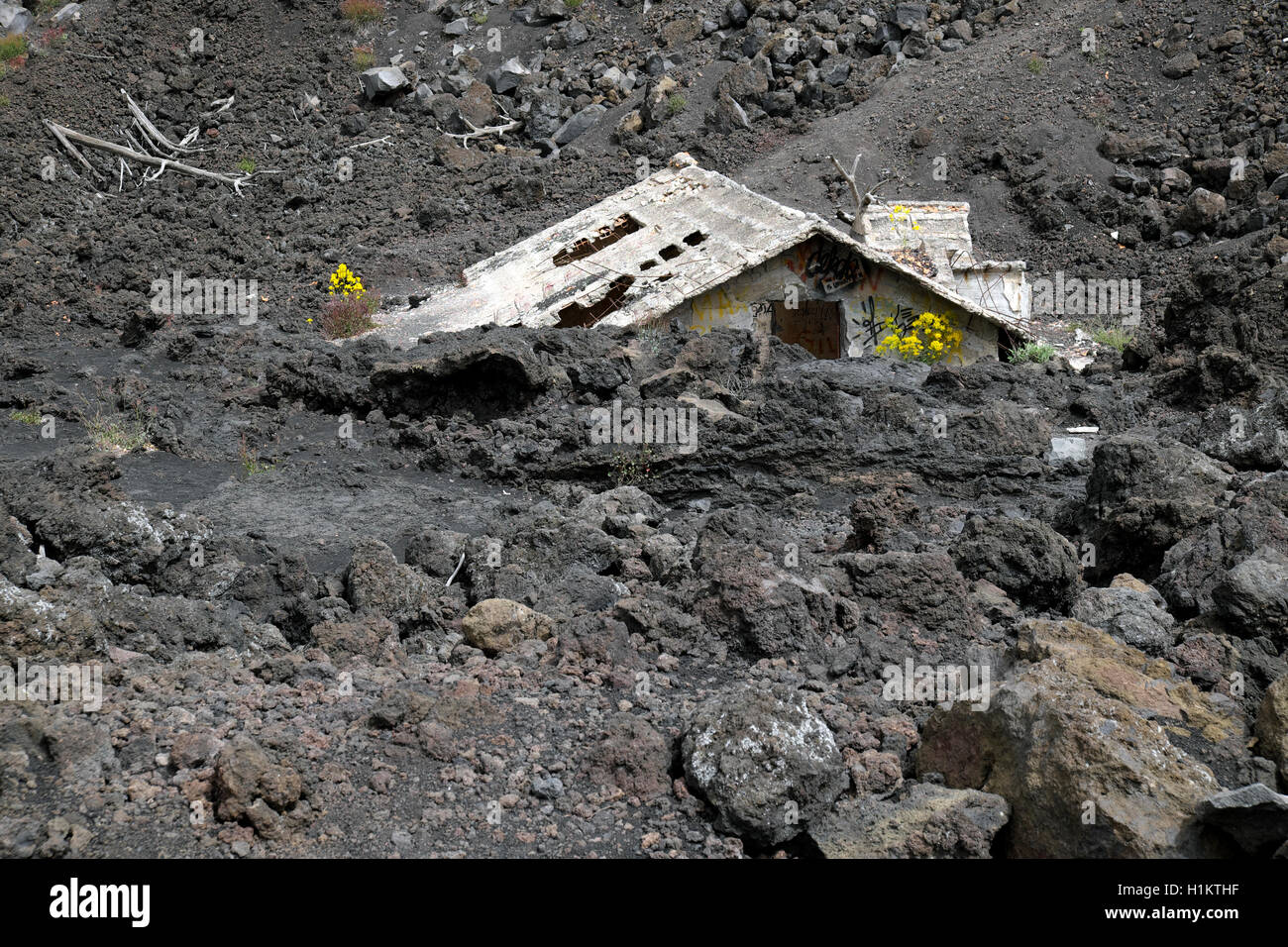 House covered with lava on the slopes of Mount Etna, Sicily, Italy