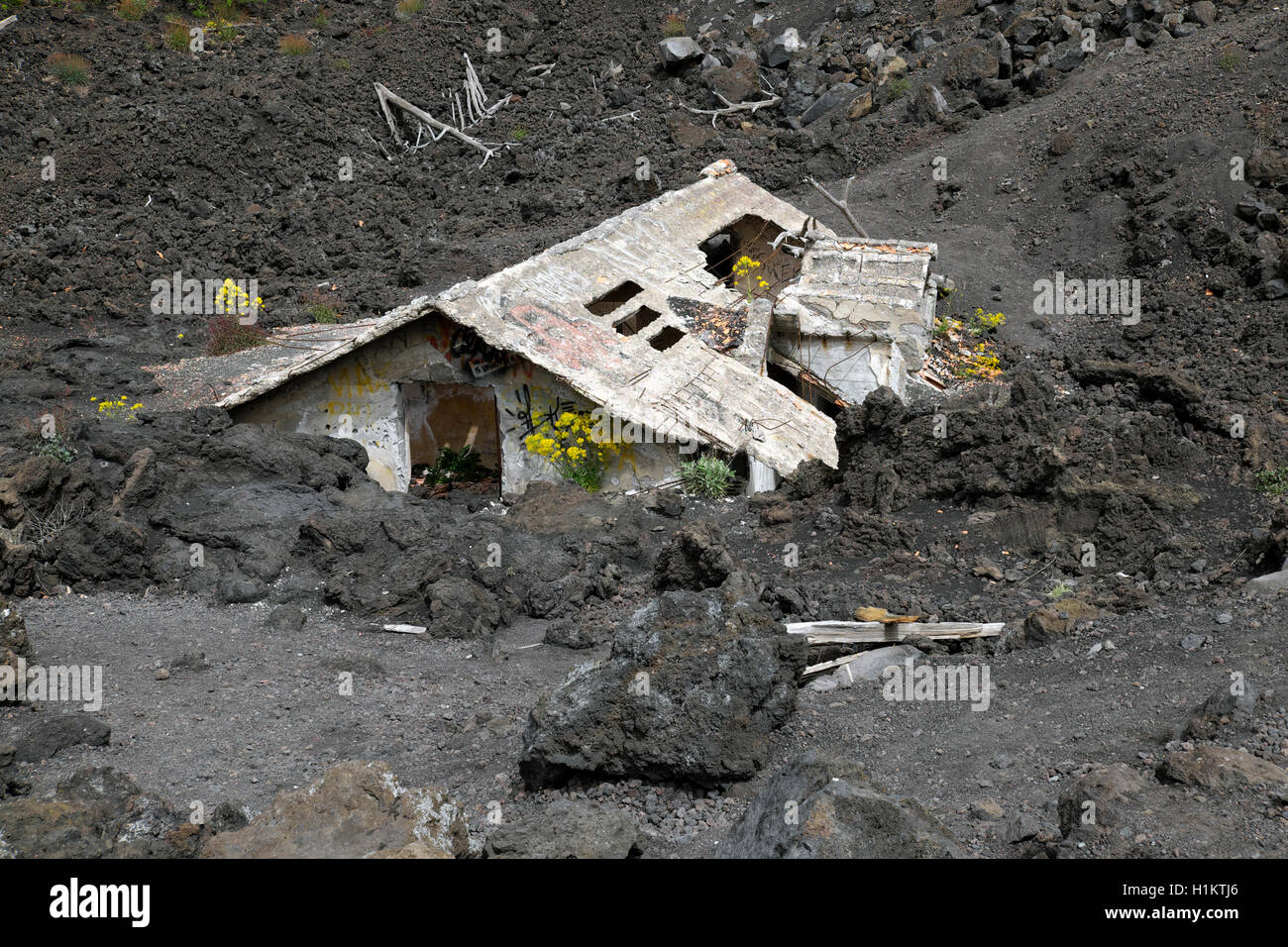House covered with lava on the slopes of Mount Etna, Sicily, Italy