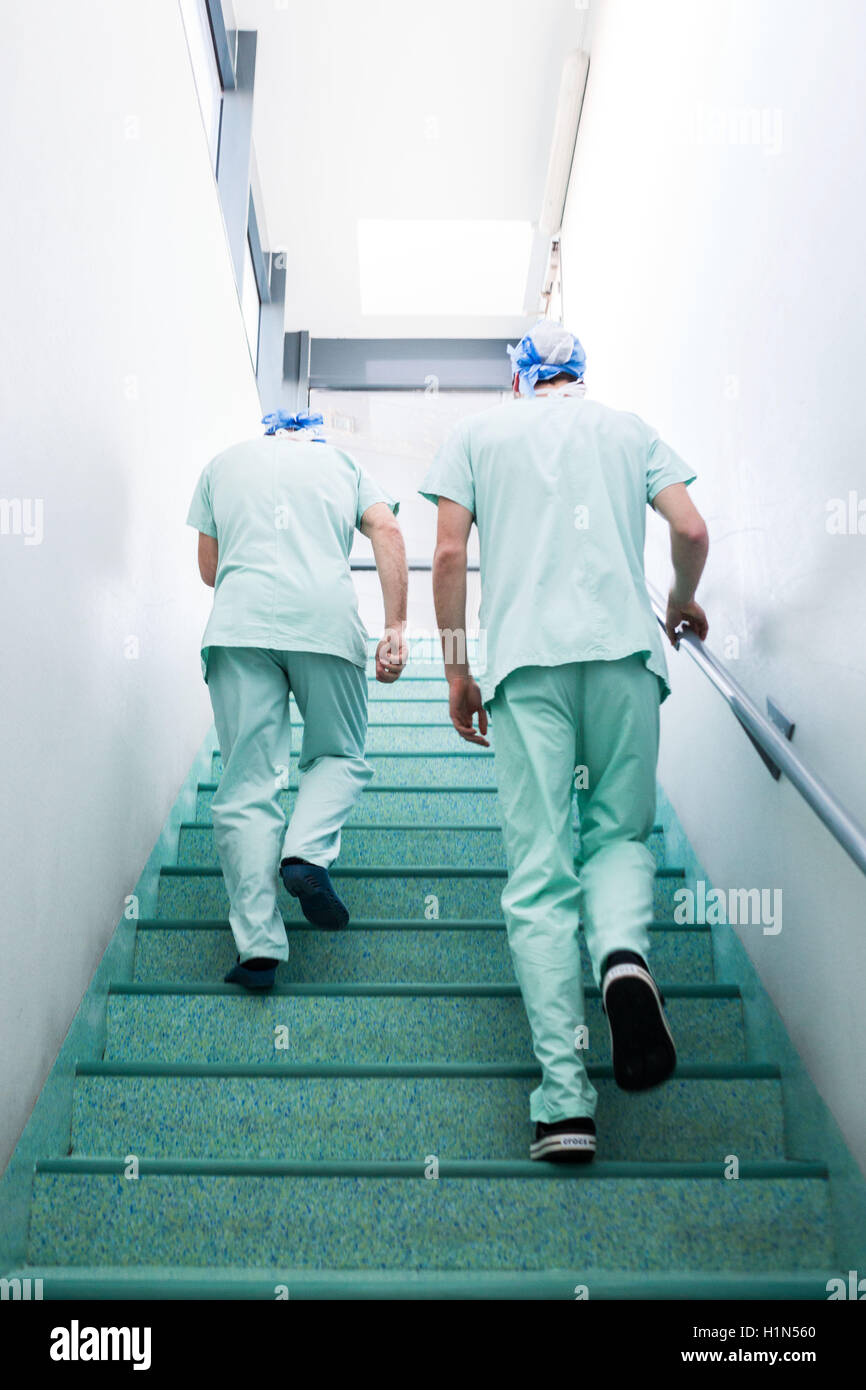 Surgical team leaving the operating room. Stock Photo
