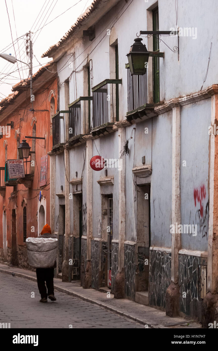 A Bolivian man hauls charcoal down a street in Potosi Stock Photo