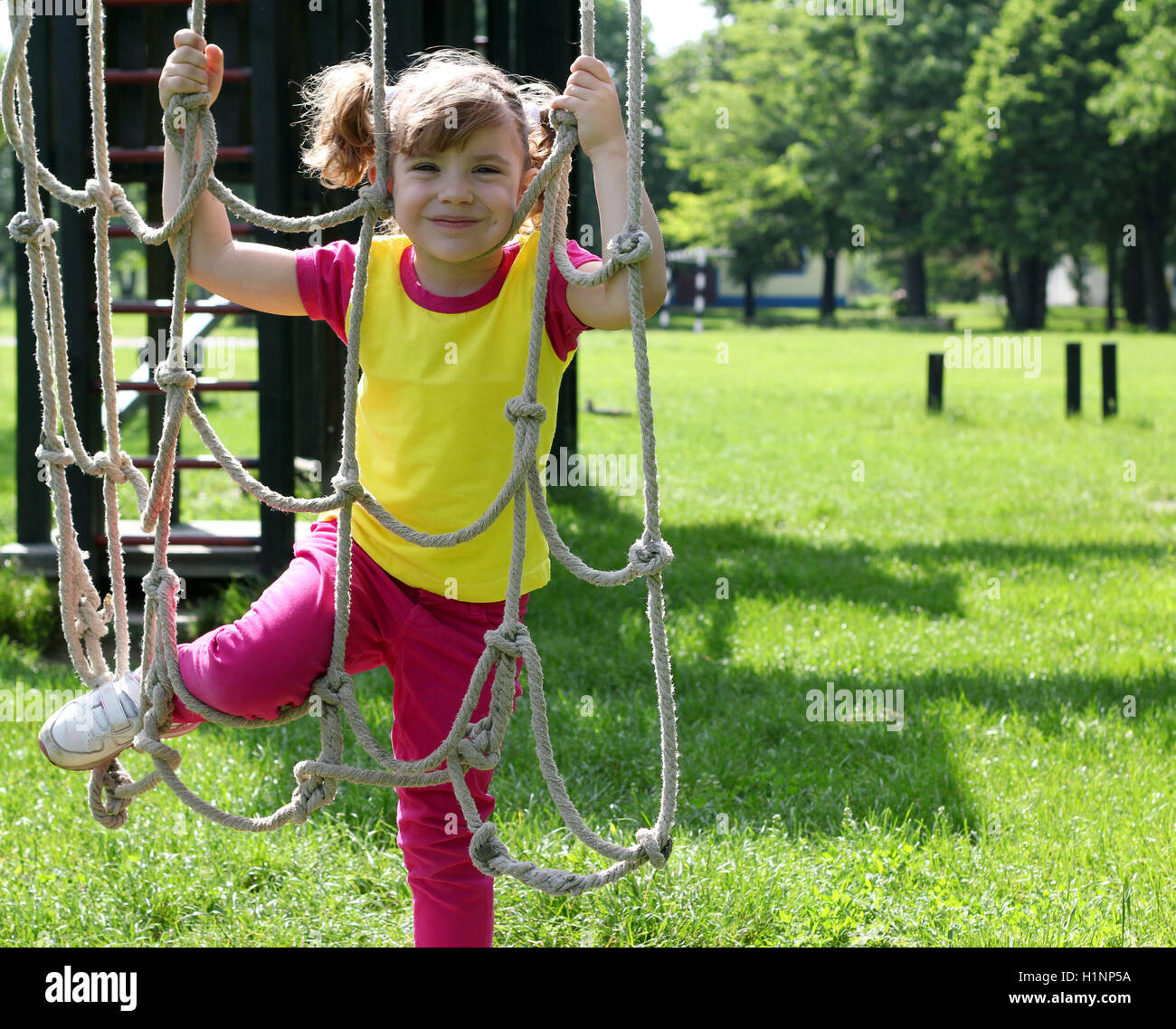 happy little girl playing on playground Stock Photo - Alamy