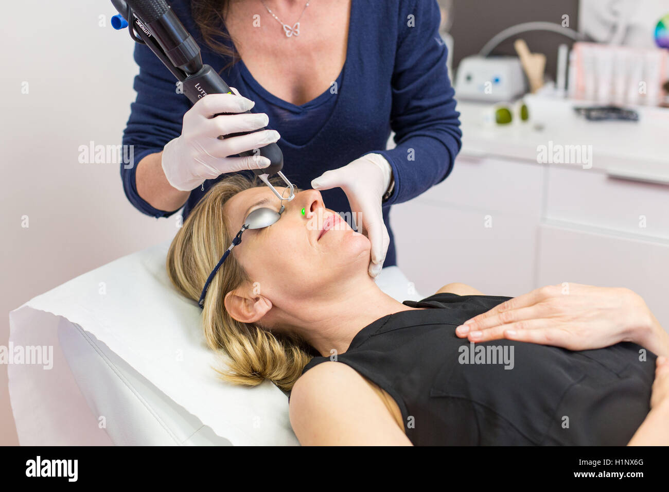 Vascular laser used in treatment of rosacea and varicosity Stock Photo