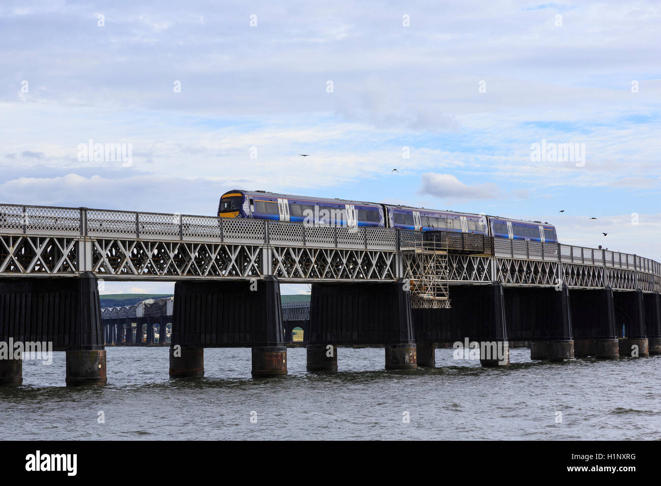Tay Rail Bridge, north end, Dundee, Scotland, with a Scotrail diesel multiple unit  (DMU) crossing. Stock Photo