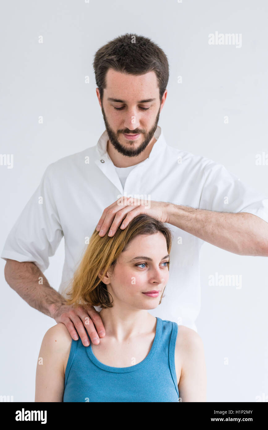 Structural osteopathy session in a woman suffering from neck pain. Stock Photo