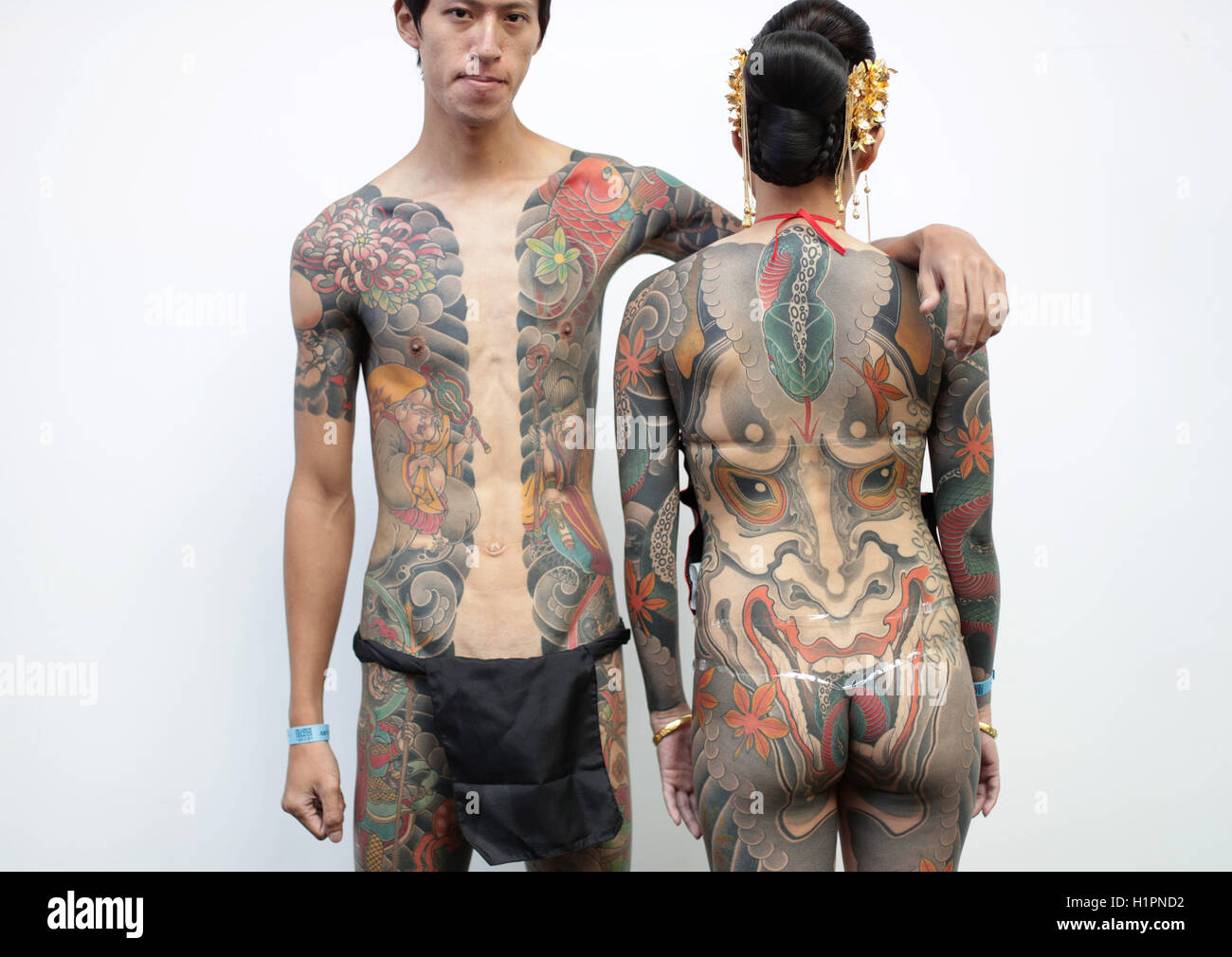 NOTE NUDITY Graffiti artist Debe (left), aged 28, and tattoo artist Hori  Mayi, 29, both from Taiwan, attending the London International Tattoo  Convention at Tobacco Dock in London Stock Photo - Alamy