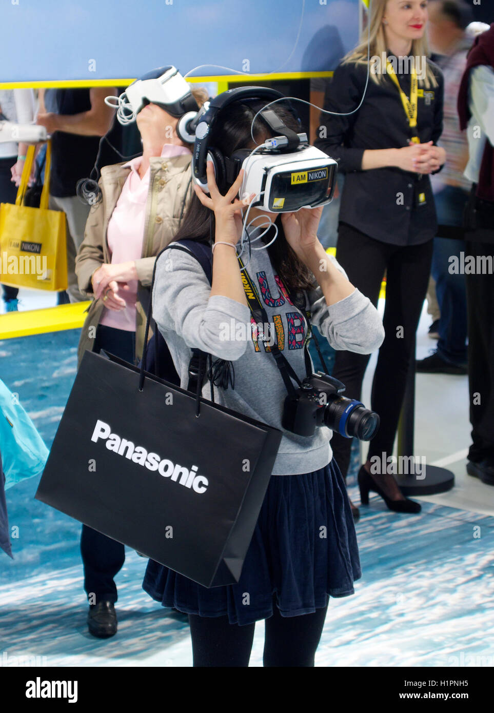 Young woman wearing VR goggles glasses at the Nikon booth on Photokina 2016, Cologne, Germany Stock Photo