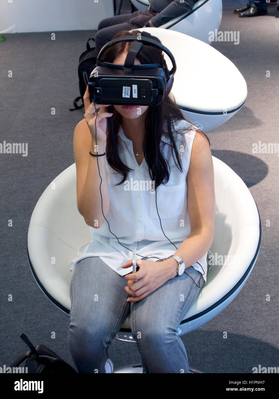 Young woman wearing VR goggles glasses on Photokina 2016, Cologne, Germany Stock Photo