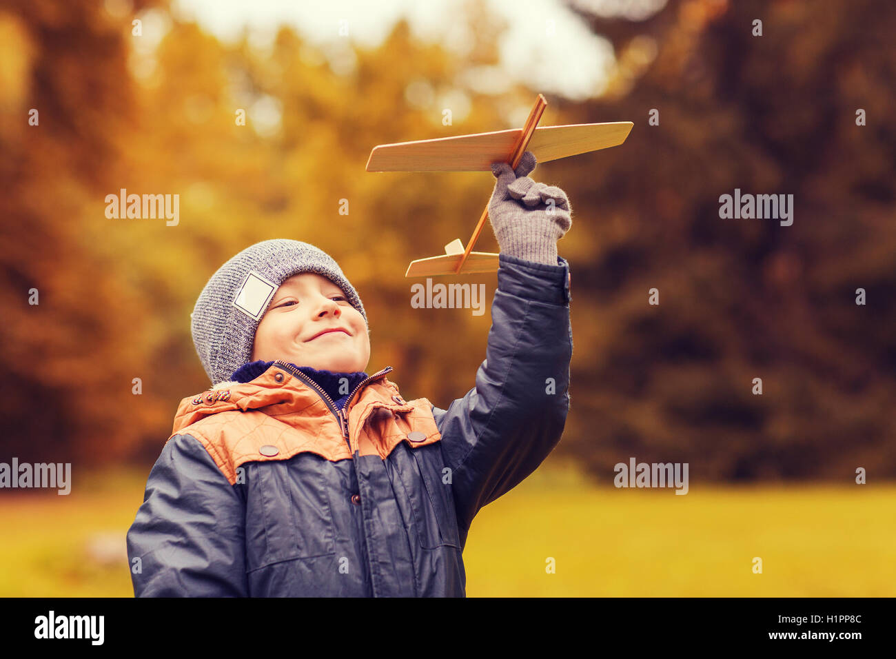 happy little boy playing with toy plane outdoors Stock Photo - Alamy