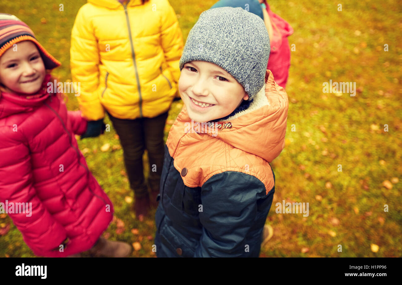 children holding hands and playing in autumn park Stock Photo