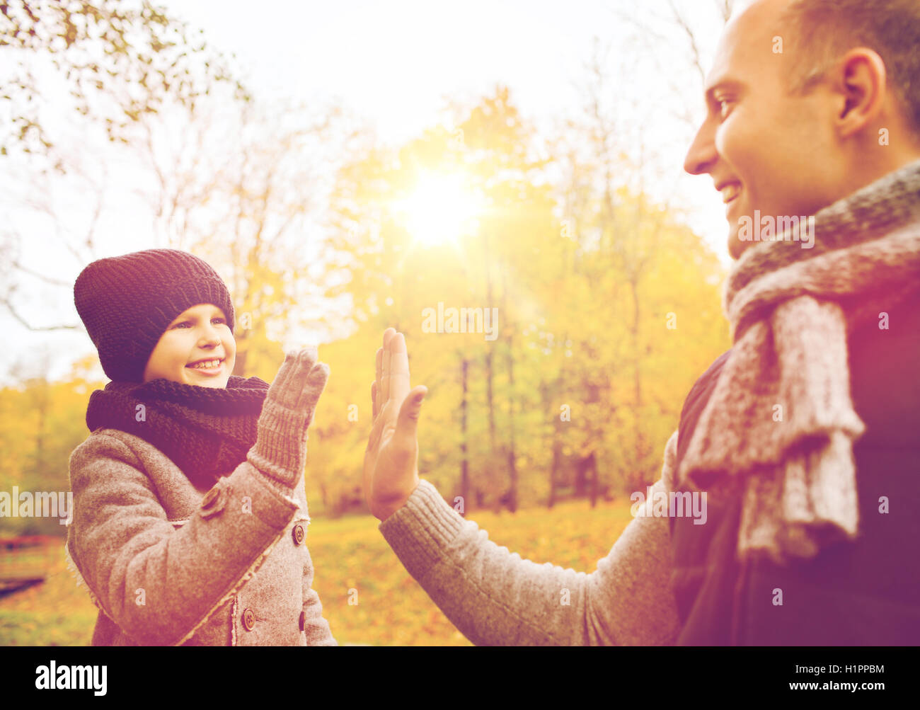 happy father and son making high five in park Stock Photo