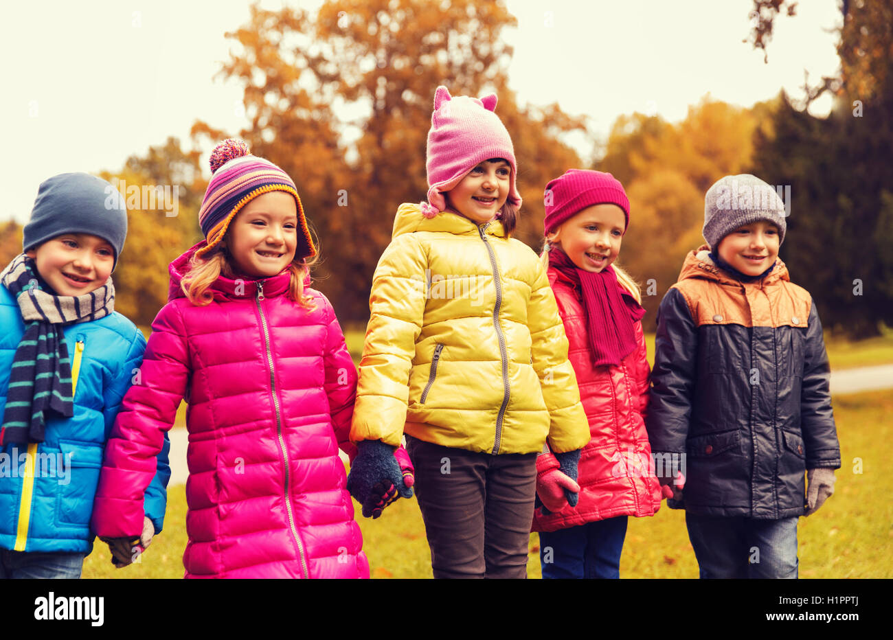 happy children holding hands in autumn park Stock Photo - Alamy