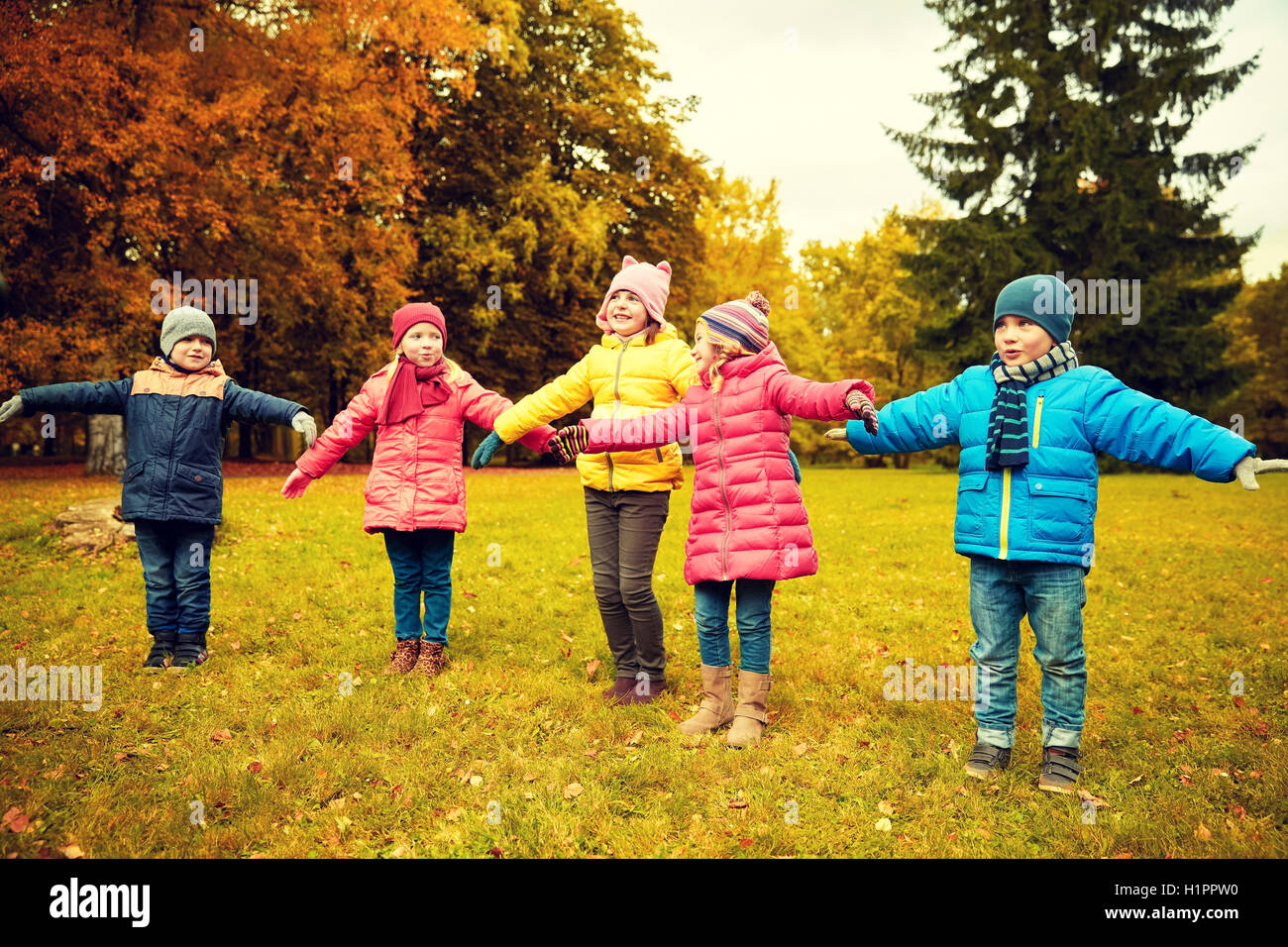 happy little children running and playing outdoors Stock Photo - Alamy