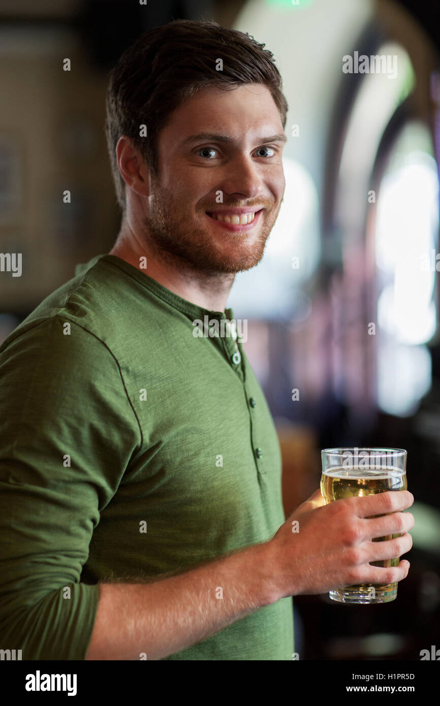 happy man drinking beer at bar or pub Stock Photo Alamy