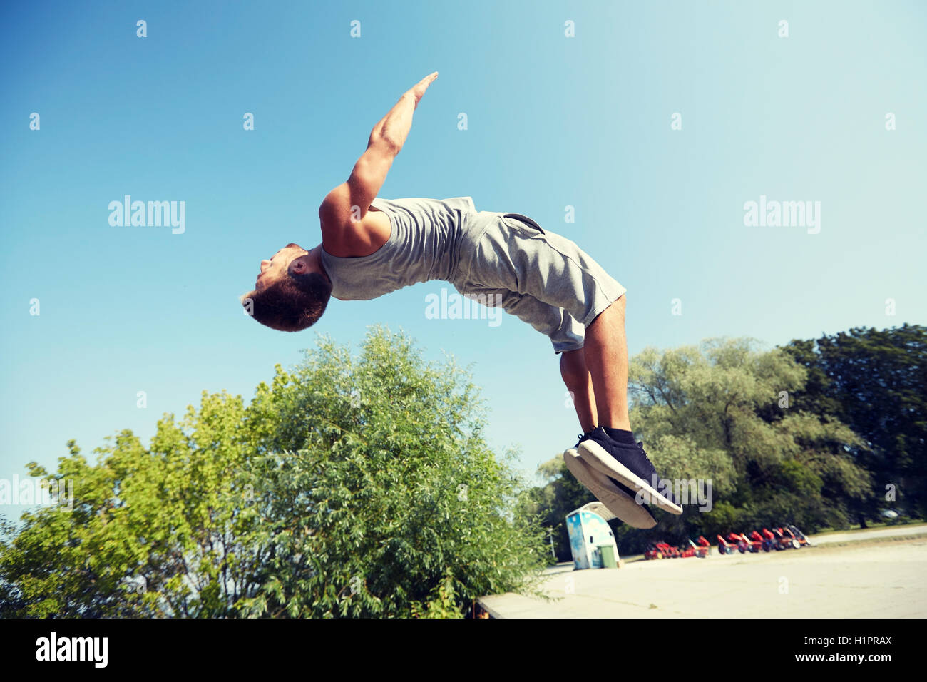 sporty young man jumping in summer park Stock Photo
