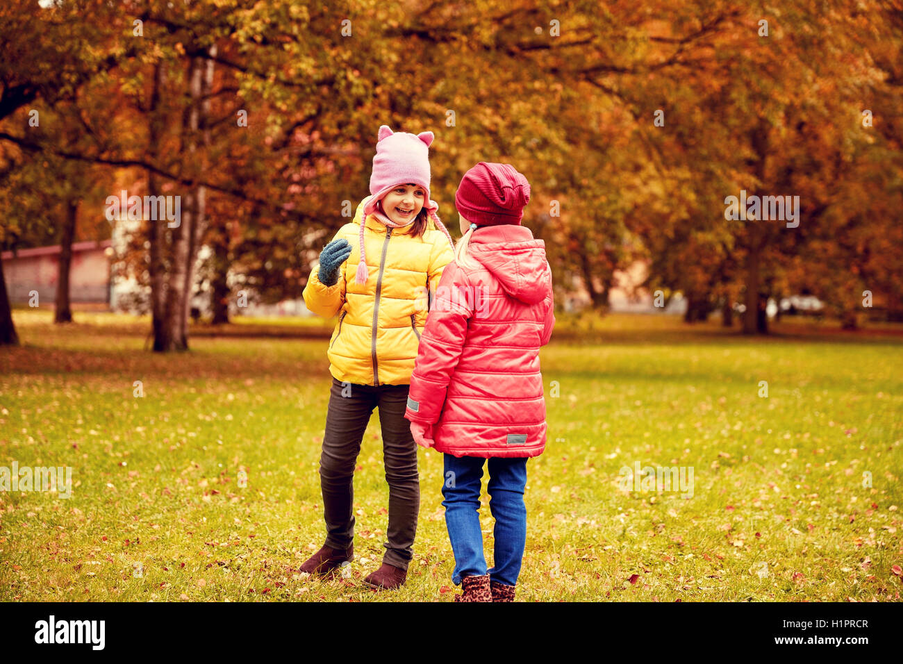 two happy little girls in autumn park Stock Photo - Alamy