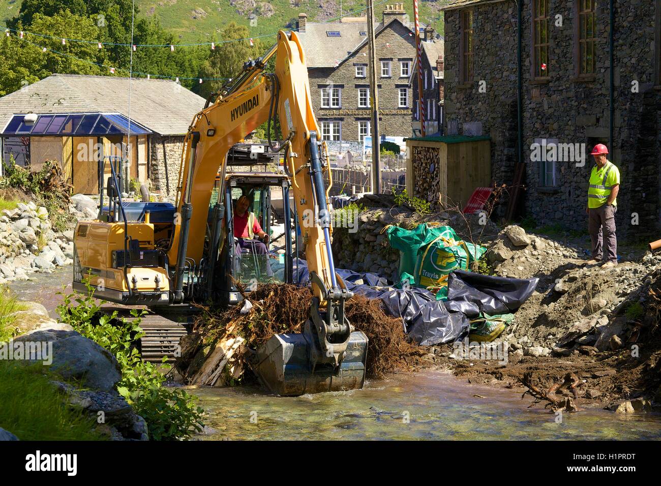 Hyundai HX140L crawler excavator clearing of the Glenridding Beck from debris from the floods. Glenridding, Cumbria, England UK. Stock Photo