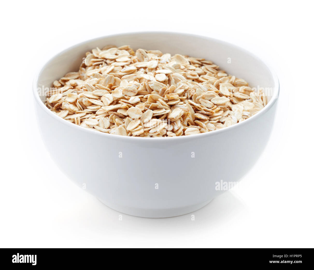 Bowl of oat flakes isolated on white background Stock Photo