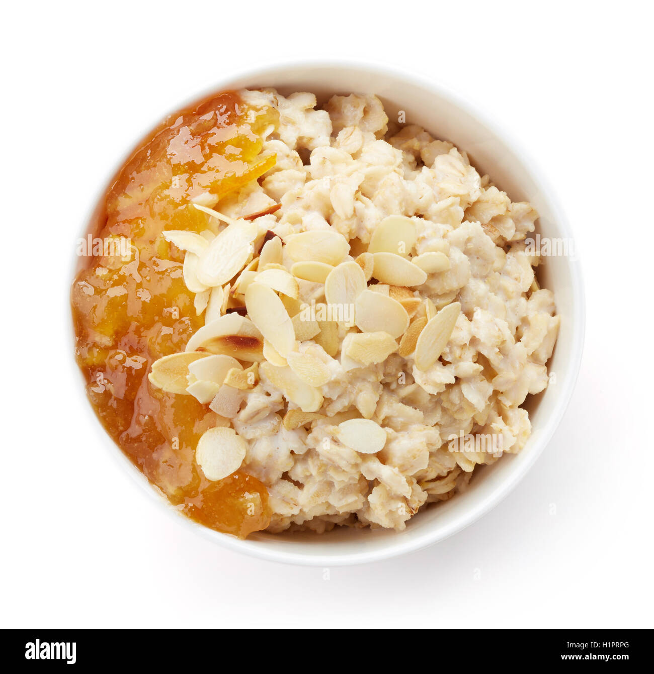 Bowl of healthy oatmeal with orange jam isolated on white background Stock Photo