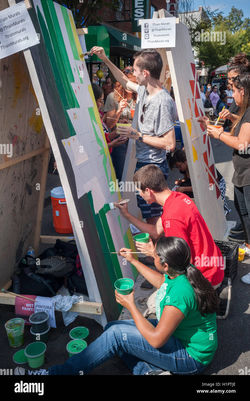 College students volunteer to paint murals toe beautify the Jackson Heights neighborhood in Queens in New York on Saturday, September 17, 2016. The Jackson Heights neighborhood is home to a mosaic of ethnic groups beside Indians which include Pakistanis, Tibetans, Southeast Asian and long-time Jewish and Italian residents.  (© Richard B. Levine) Stock Photo