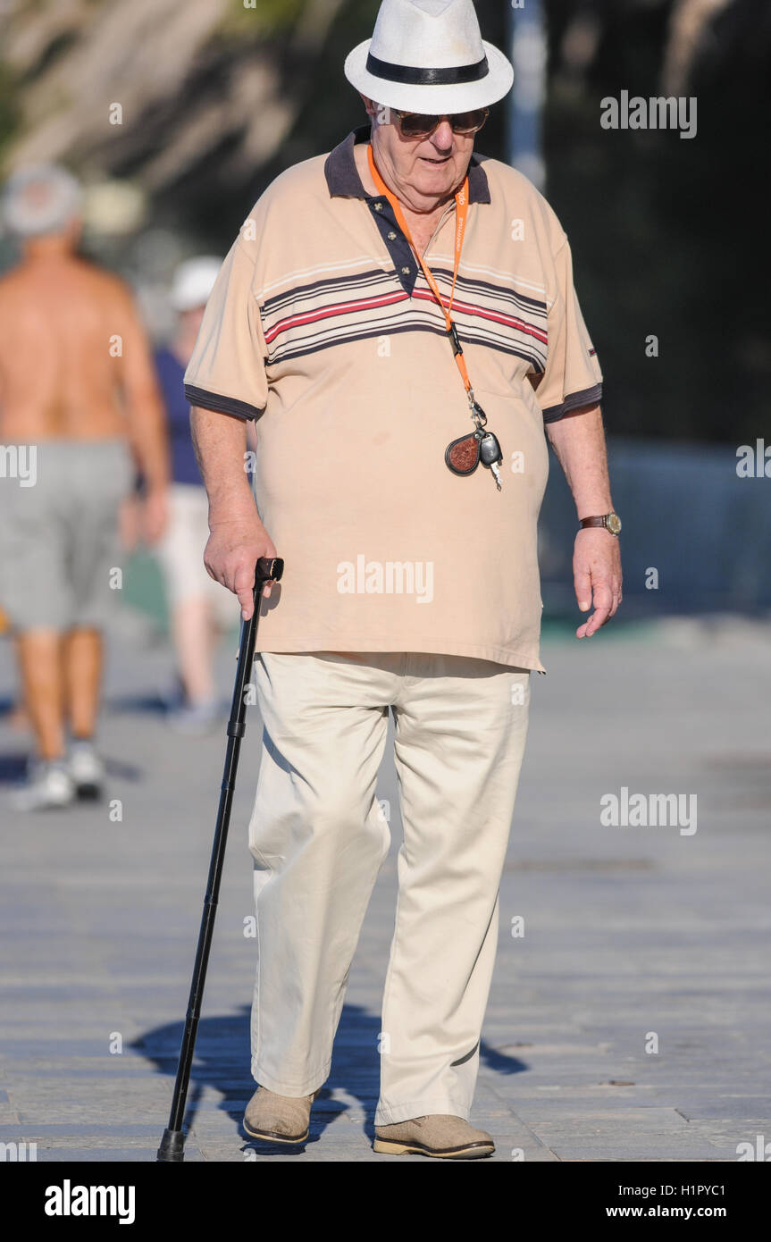 Old man with walking stick hi-res stock photography and images - Alamy