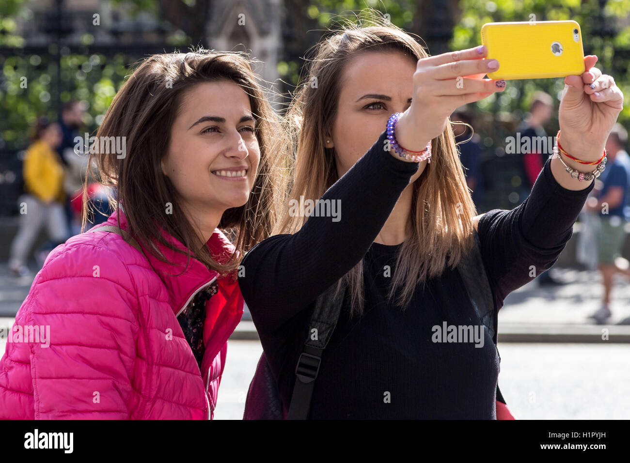 Tourists taking photos and phone selfies in Westminster, London, UK. Stock Photo