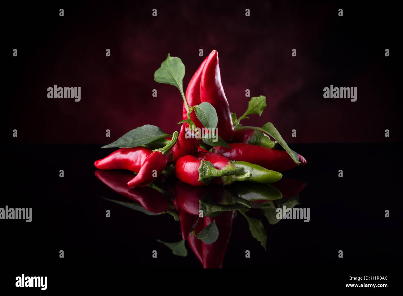 red chili peppers on the black background. Stock Photo