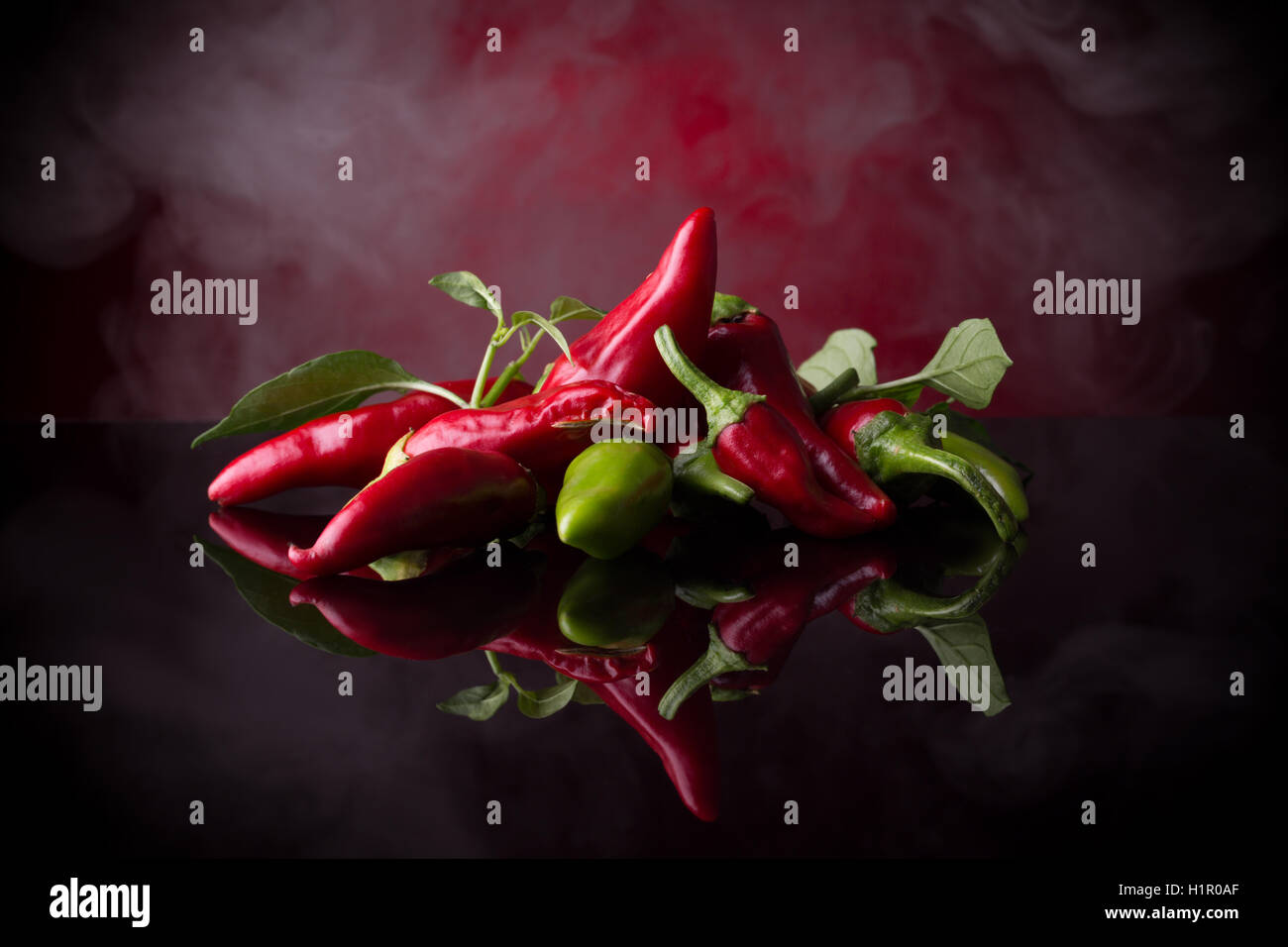 red chili peppers on the black background. Stock Photo