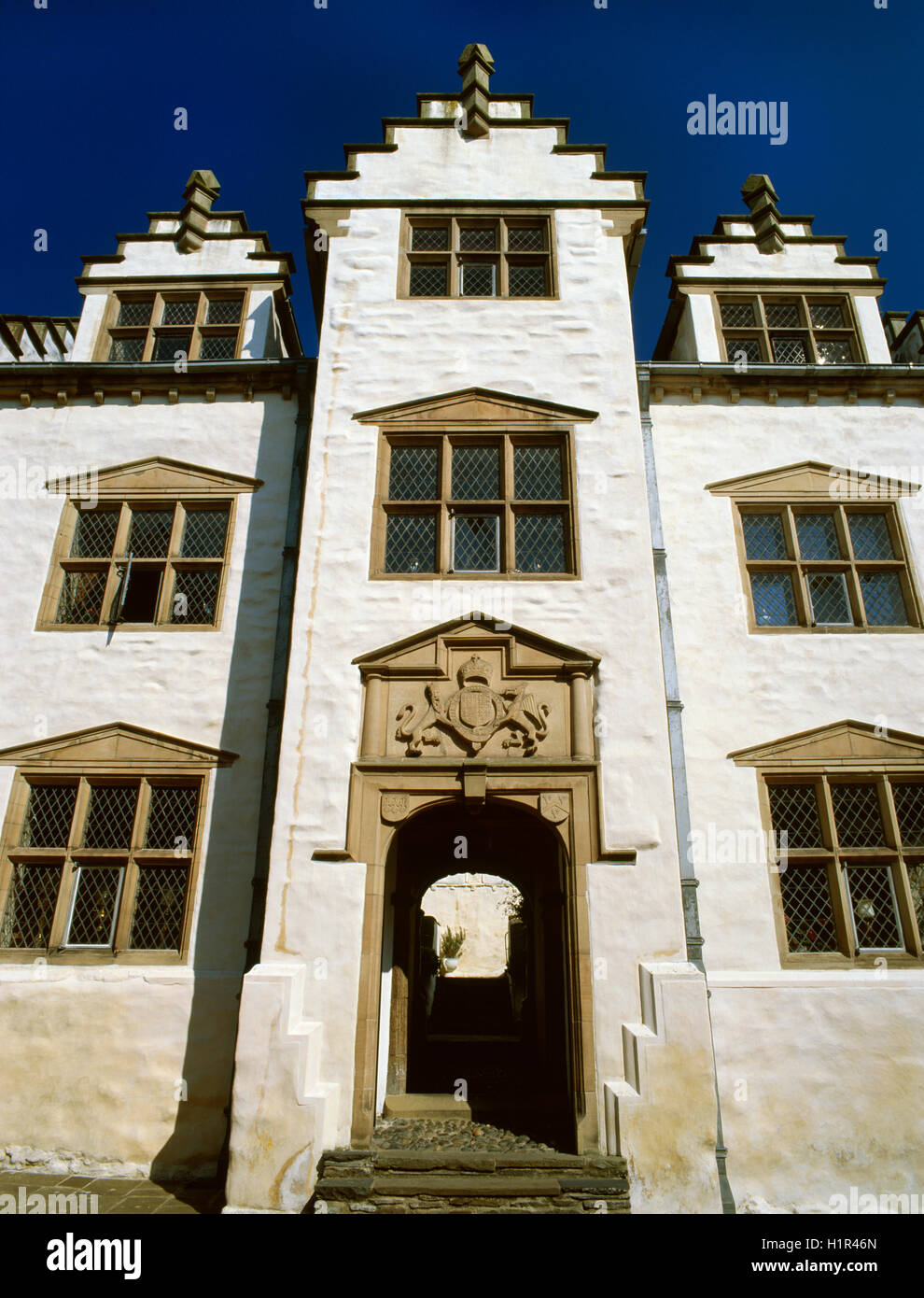 Looking up from Conwy High Street at the gatehouse to Plas Mawr, probably the best preserved Elizabethan townhouse in Britain. Stock Photo