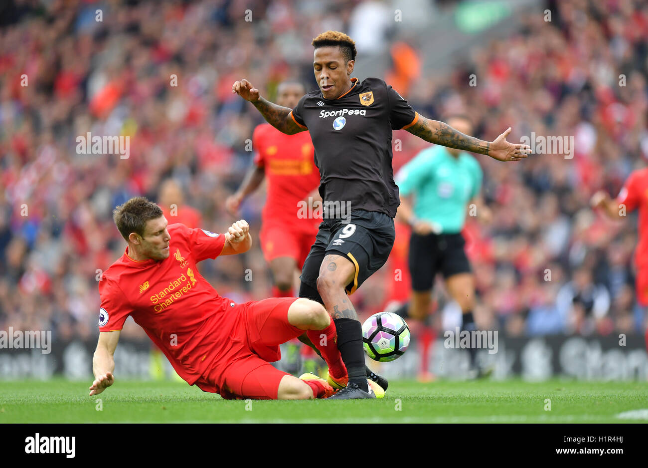 Hull City's Abel Hernandez (right) and Liverpool's James Milner battle for the ball during the Premier League match at Anfield, Liverpool. Stock Photo