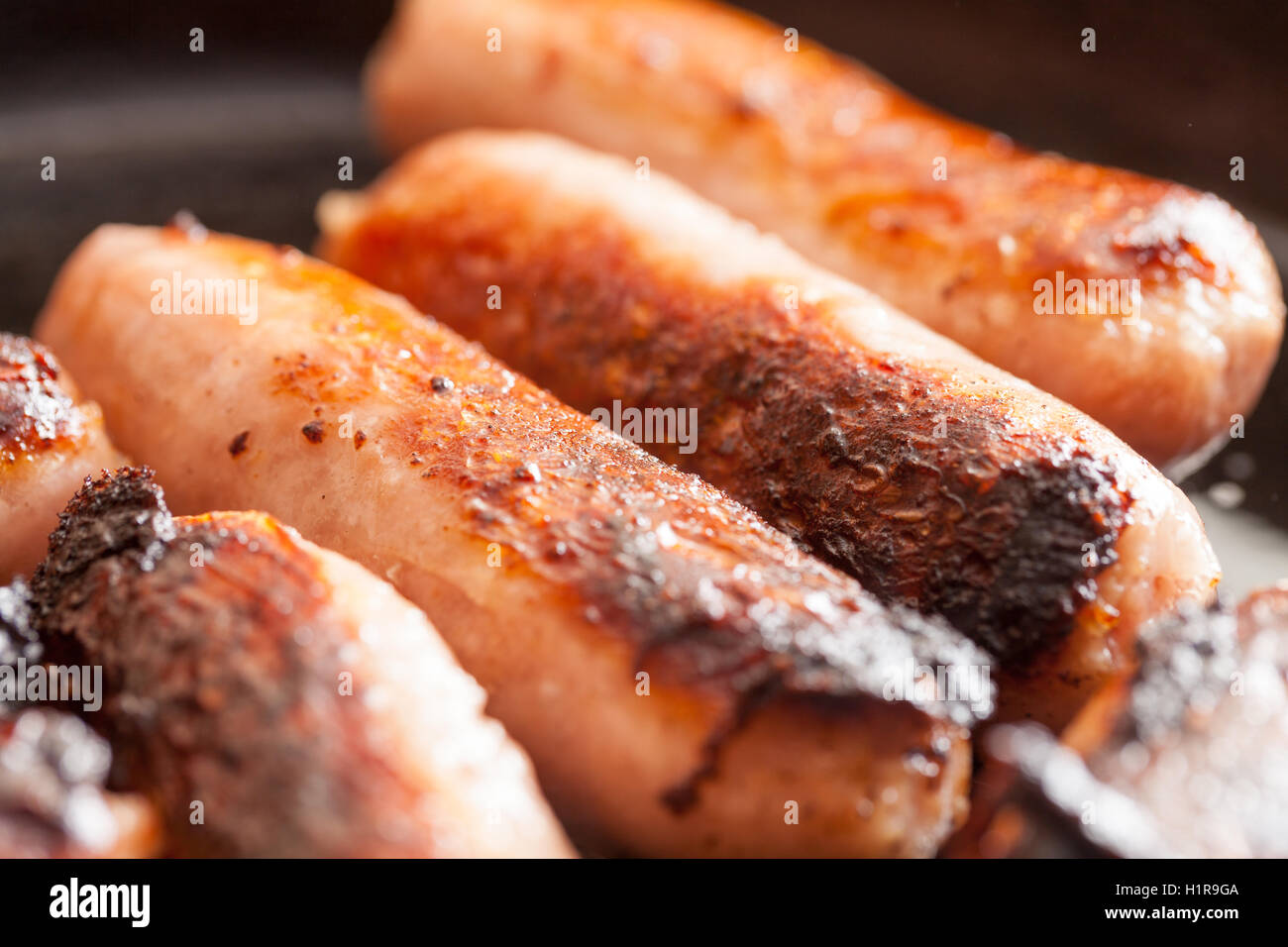British sausages cooking in a frying pan Stock Photo Alamy