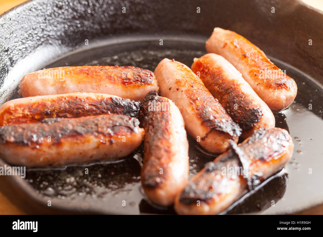 British sausages cooking in a frying pan Stock Photo Alamy