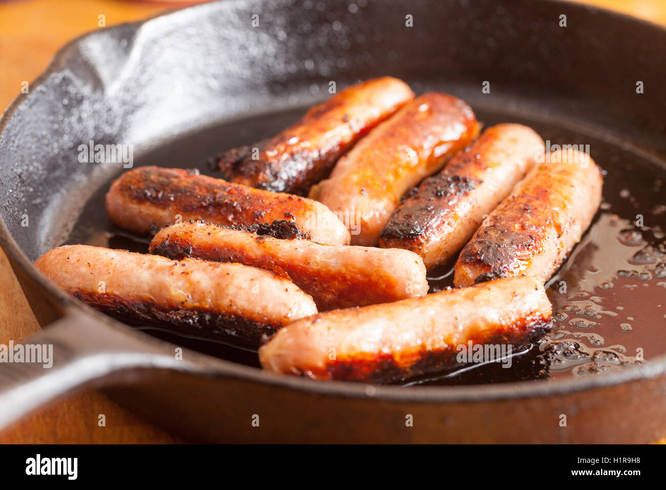 British sausages cooking in a frying pan Stock Photo Alamy