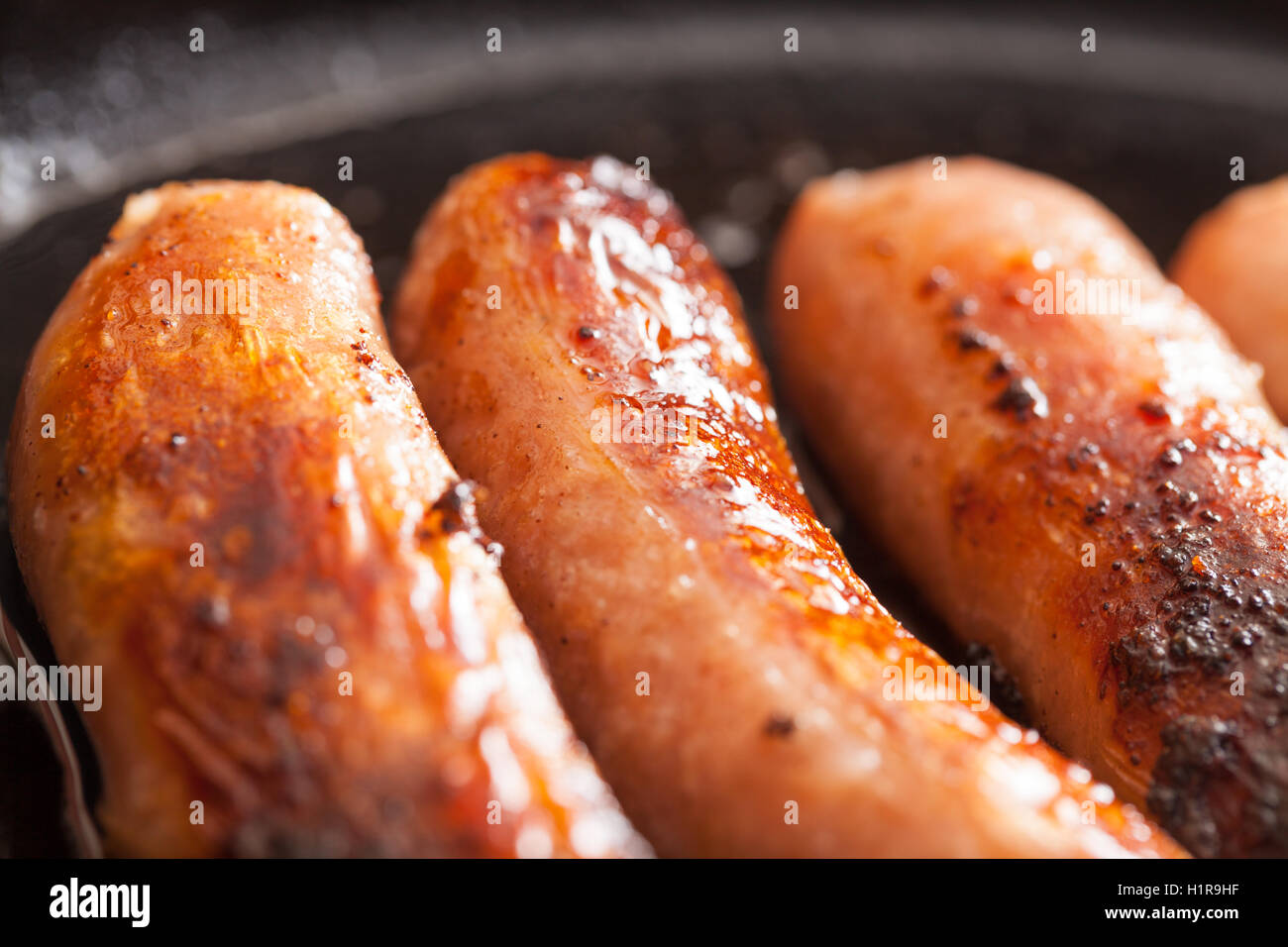 British sausages cooking in a frying pan Stock Photo Alamy