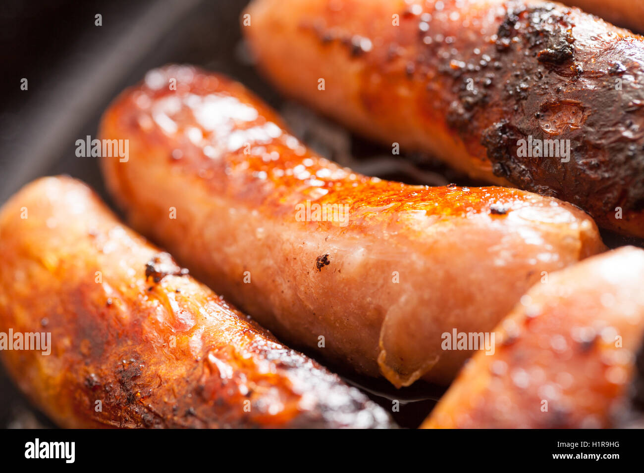 British sausages cooking in a frying pan Stock Photo Alamy