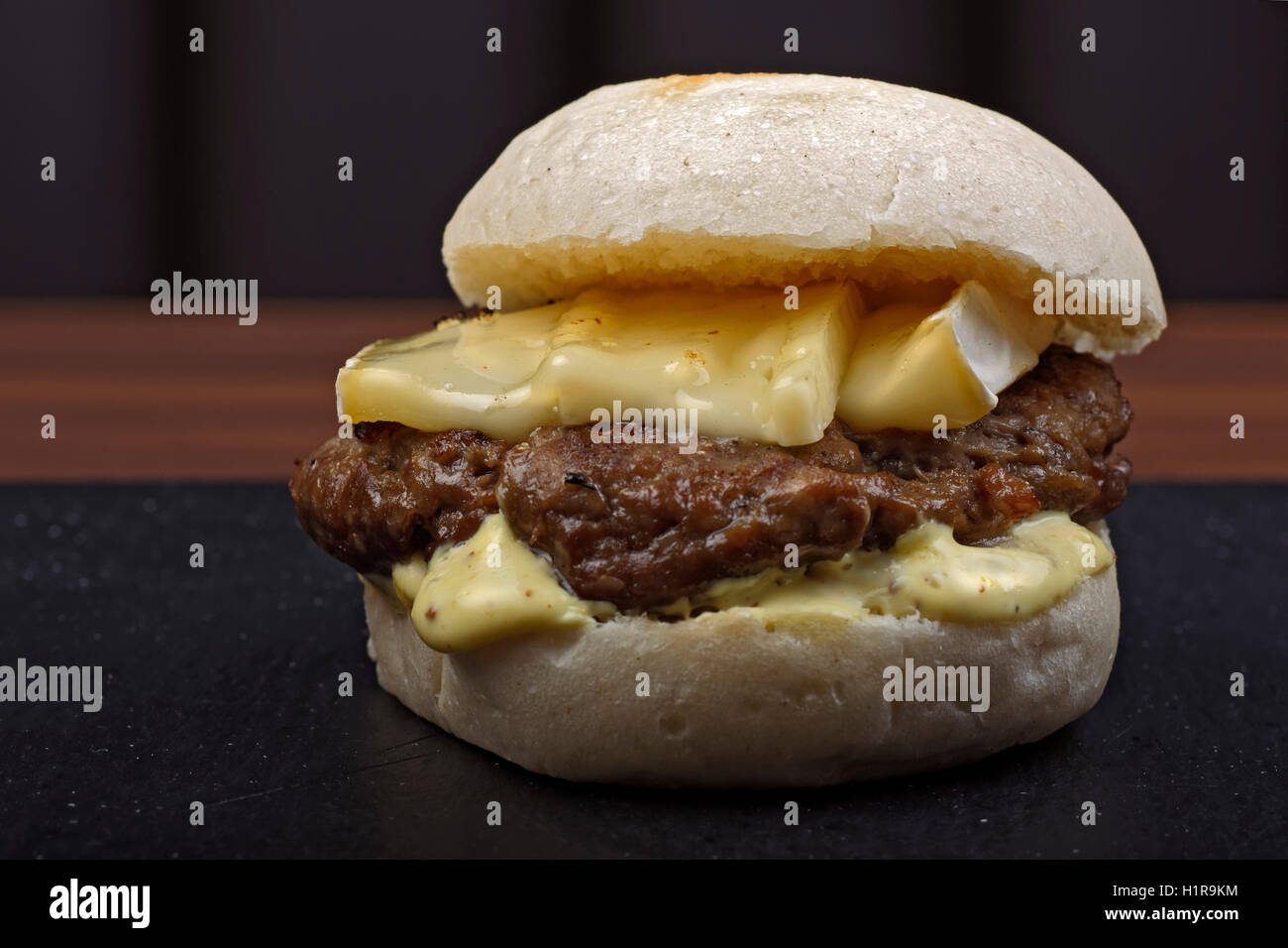 Hamburger with melted cheese. Stock Photo