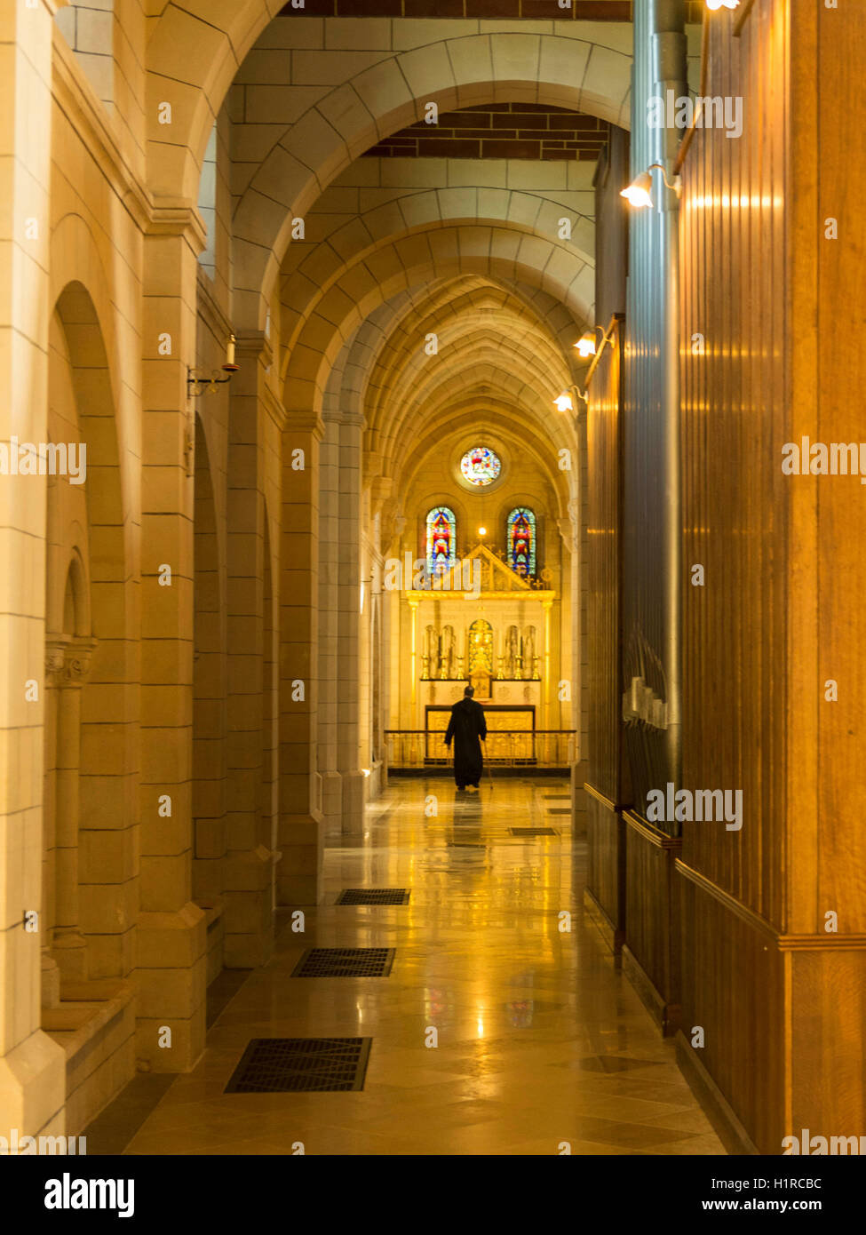 A monk takes daily stroll around the beautiful abbey framed by the