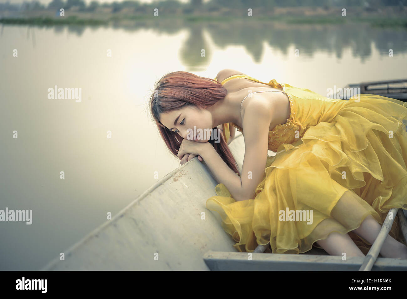 Portrait of Asia Beautiful woman in yellow dress sitting on boat Stock ...