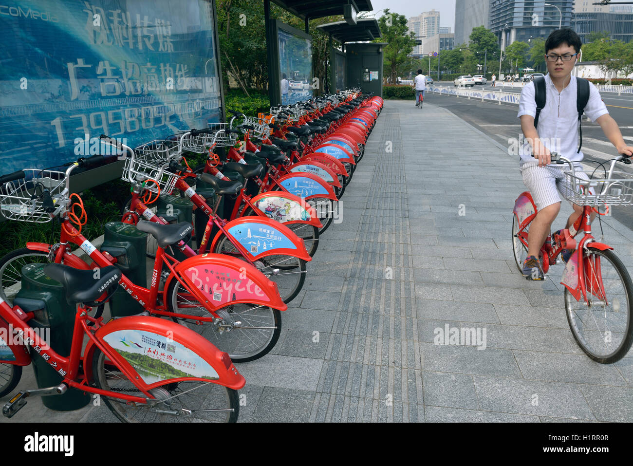 A man using a public bicycle in Hangzhou, Zhejiang province, China ...
